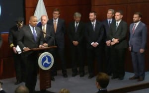 Dr. Gregory S. McNeal (first on right) stands on stage with Secretary of Transportation Foxx during the announcement of the Drone Registration Task Force.  